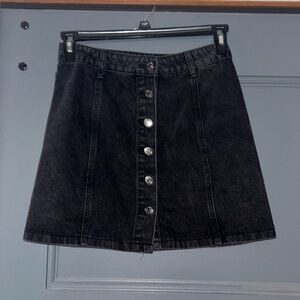 This medium, black, denim skirt is a cute piece when fall comes around.